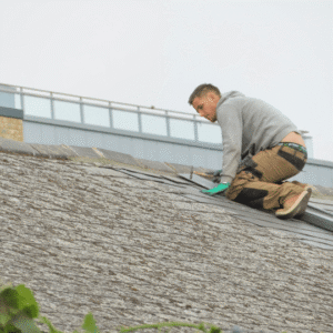 a roofing contractor inspects and repairs the edge of a commercial roof, highlighting the key maintenance components such as checking for leaks, securing flashing, and preventing water infiltration.