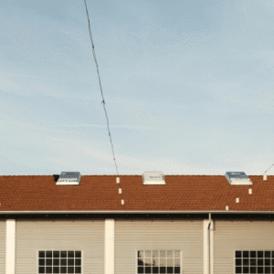 a well-maintained commercial building with a clean tiled roof and skylights, emphasizing the key takeaways of regular roof maintenance, including longevity, cost savings, and insurance compliance.