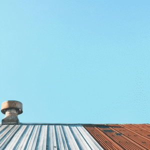 a metal roof with a section showing rust and wear, emphasizing the importance of preventative maintenance to extend roof lifespan and prevent costly repairs.