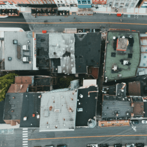 an aerial view of multiple commercial rooftops in varying conditions, emphasizing the importance of professional roof inspections to identify damage, ensure proper maintenance, and extend roof lifespan.